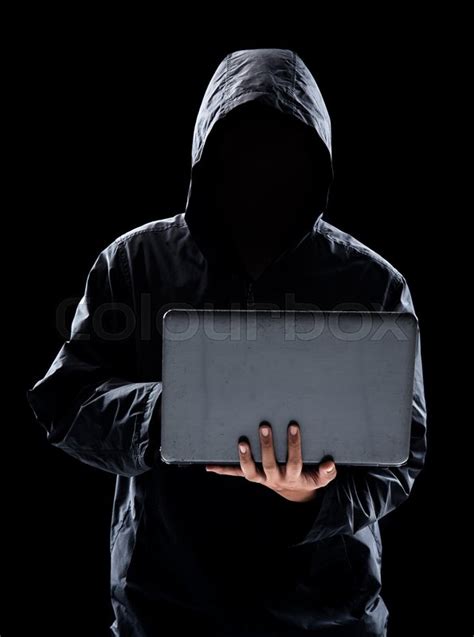 Hacker with hidden face in a hoodie ... | Stock image | Colourbox