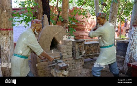 Mannequins work as a blacksmith forging iron in Turpan Karez Well museum, Xinjiang Province ...