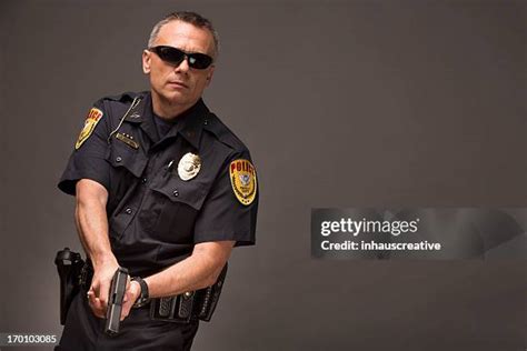 Cop Holding Gun Photos and Premium High Res Pictures - Getty Images