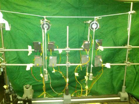 View of the two-pendulum experiment. Two pendula are suspended from a... | Download Scientific ...