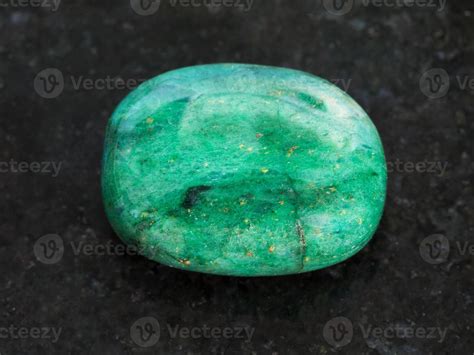 polished green beryl gemstone on dark background 14937599 Stock Photo at Vecteezy