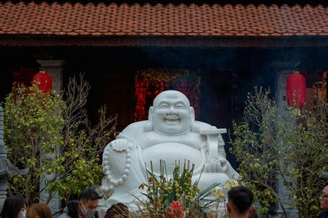 Buddha Sculpture among Trees near Temple · Free Stock Photo