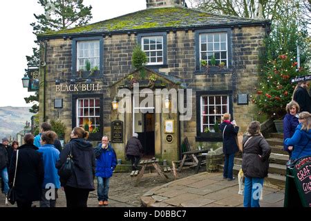 haworth main street at christmas black bull pub and xmas decorations Stock Photo - Alamy