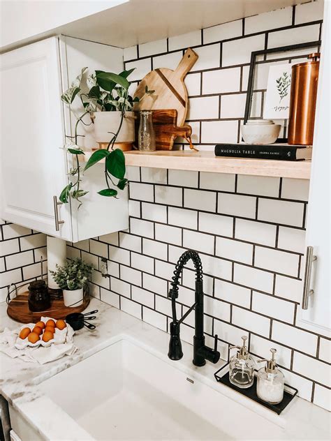 This modern farmhouse kitchen is full of black and white decor, accents ...