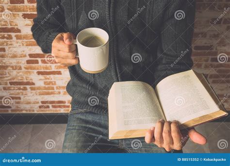 Closeup of a Young Man Reading a Book while Drinking Coffee from Stock Photo - Image of drinking ...