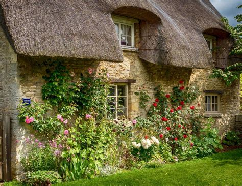 Lovely old thatched cottage in the village of Minster Lovell in the Cotswolds of Oxfordshire ...