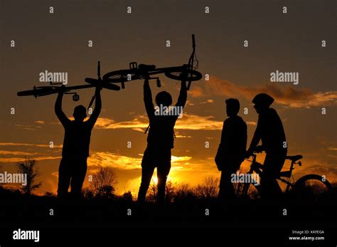 Mountain Bikers in silhouette Stock Photo - Alamy