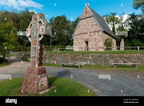 Beautiful shot of an early Christian cross and a church in Irish ...