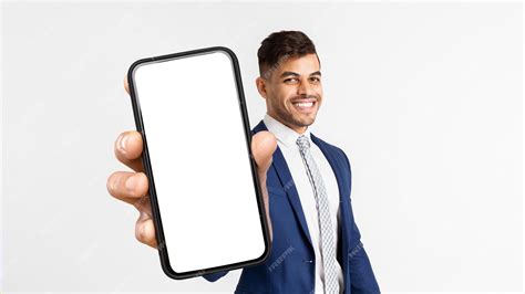 Premium Photo | Happy Arab Man Smiling And Showing Cell Phone Mockup