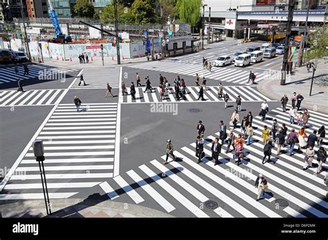 Japanese street scene showing crowds of people crossing the street on a pedestrian crossing in ...