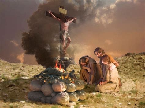 three people sitting around a campfire with a man on the cross in the background