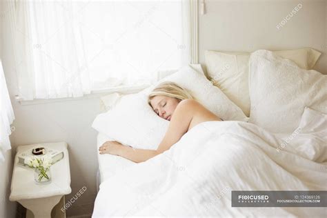 Woman sleeping in a bed — weekend lie in, solitude - Stock Photo ...