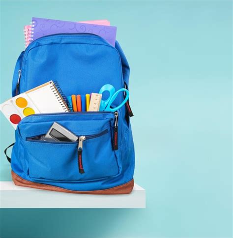 Premium Photo | School backpack with stationery on wooden table