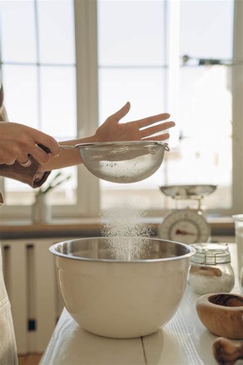 A Person Sifting Flour · Free Stock Photo