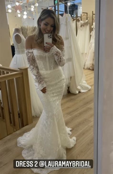 Amy Dowden tries on wedding dresses after being forced to postpone day