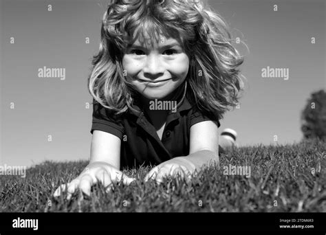 Portraits of happy kids playing and laying on grass outdoors in summer ...