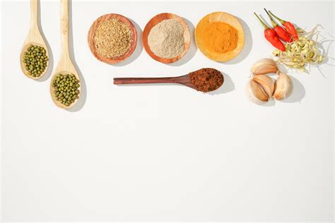 the variety of spices and herbs on a white background. a simple culinary background with copy ...