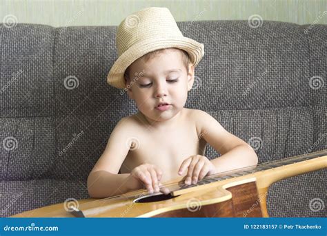 Child playing the guitar stock image. Image of alone - 122183157