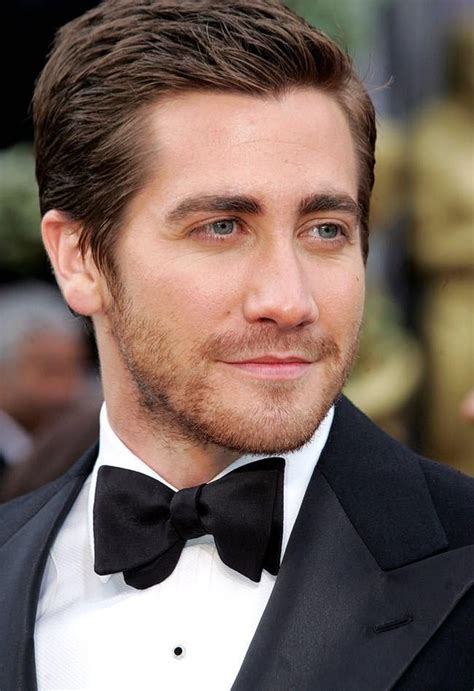 a close up of a person wearing a tuxedo and looking at the camera