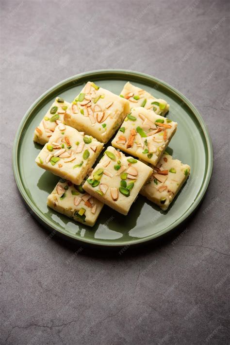 Premium Photo | Milk powder barfi also known as mava burfi white khoya burfi or barfee indian ...