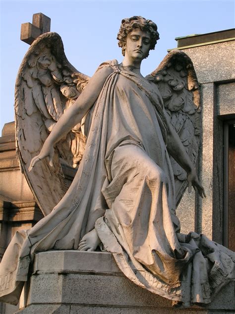 Sculpture on a gravestone in the monumental cemetery in Milan, Italy ...