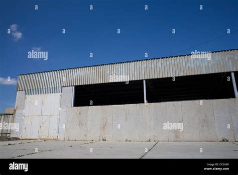 Old abandoned warehouse exterior wide angle view Stock Photo - Alamy