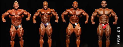 In this picture you see four bodybuilders who are posing to the judge in a competition. A lot of ...