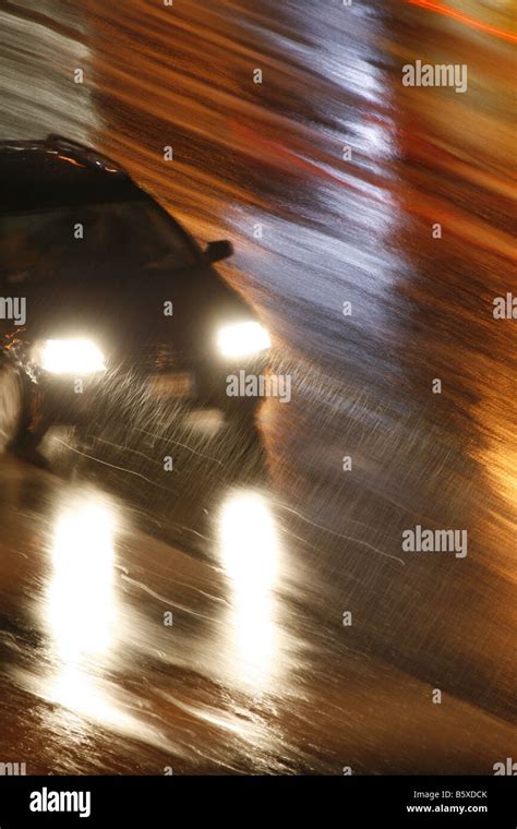 fast car driving in heavy rain at night in town Stock Photo - Alamy