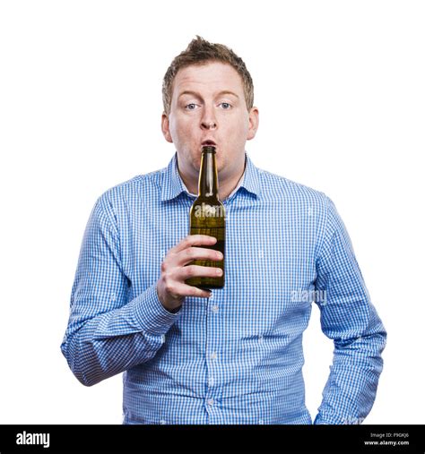 Funny young drunk man holding a beer bottle. Studio shot on white ...