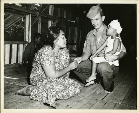 Coast Guardsman giving a Marshallese woman a cigarette, Marshall ...