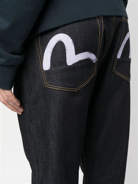 EVISU logo-print Tapered Jeans - Farfetch