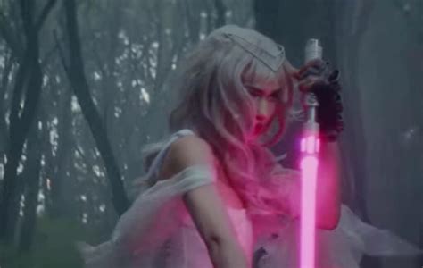 Watch Grimes wield a lightsaber in the 'Player of Games' video