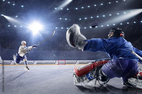 Hockey players shoots the puck and attacks Photos | Adobe Stock