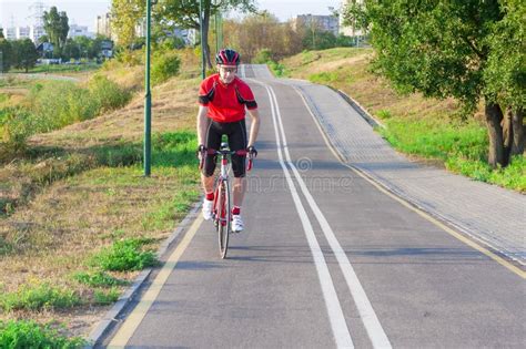 Road Cycling. One Emotional Male Cyclist Riding Road Bike Uphill ...