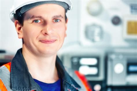 Premium Photo | Young positive engineer in helmet and construction vest ...