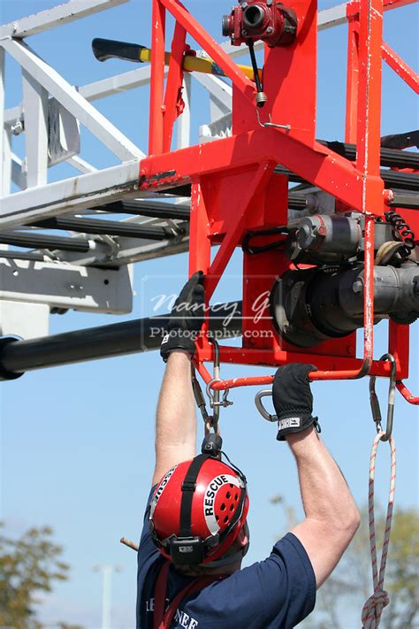 An aerial rescue using a ladder truck with the firefighter hooking up the ropes | Nancy Greifenhagen