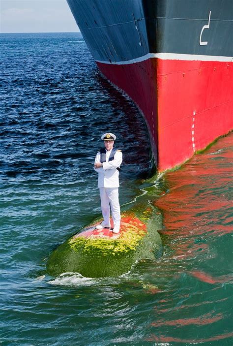 Captain Kevin Oprey, Master of Queen Mary 2, standing on the ship’s bulbous bow (a protruding ...