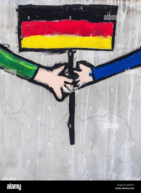 german flag with hands as graffiti on a wall Stock Photo - Alamy