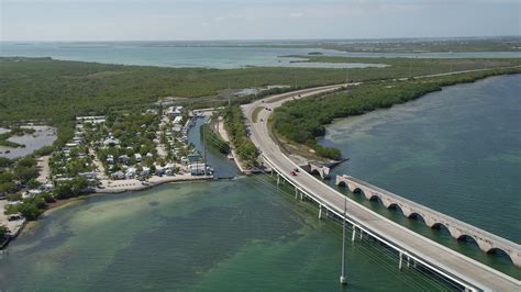 5K stock footage aerial video of following Overseas Highway past Big Pine Key Fishing Lodge, Big ...