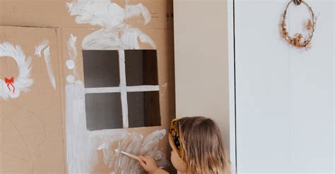 Girl Painting Cardboard House · Free Stock Photo