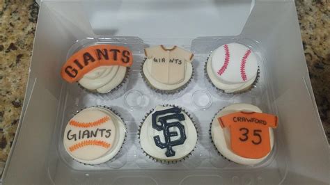 cupcakes decorated to look like the san francisco giants are in a plastic box