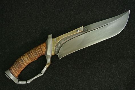 a knife with a wooden handle on a black surface