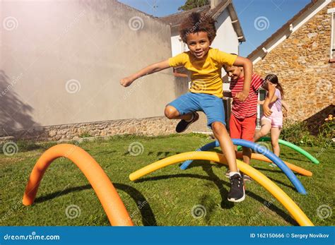 Race Game with Obstacles Boys Jump Over Barrier Stock Photo - Image of ...