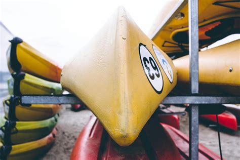 Closeup Photo of Yellow Kayak on Gray Metal Rack · Free Stock Photo