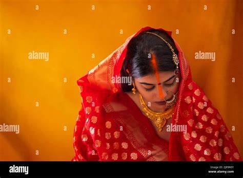 Bride from Bihar in the midst of sindoor ceremony, in a traditionally ...