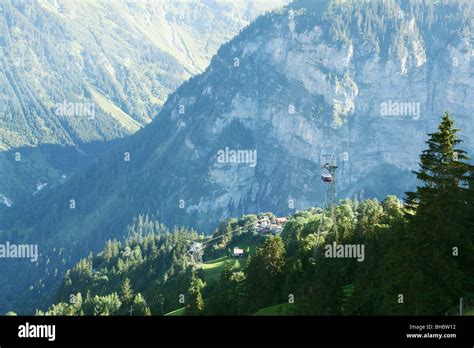 Wide view of cable car and valley in Switzerland town of Gimmelwald ...