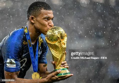 Kylian Mbappe of France kisses the World Cup trophy following the ...