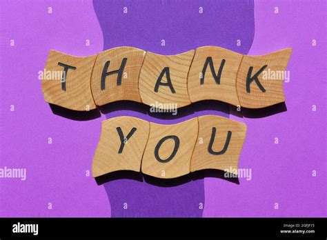 Thank You, words in wooden alphabet letters isolated on blue and purple background as banner ...