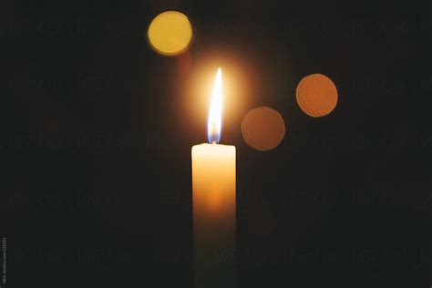 "Single Candle Flame, Black Background" by Stocksy Contributor "Mattia" - Stocksy