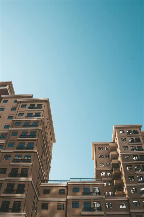 Low Angle Photography of High-rise Buildings Under Blue Sky · Free ...